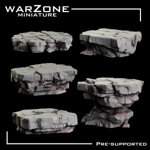 May include: A selection of grey miniature rock formations, suitable for tabletop gaming. The image shows different sizes and shapes of rocky terrain, with the text "WARZONE MINIATURE" and "PRE-SUPPORTED".
