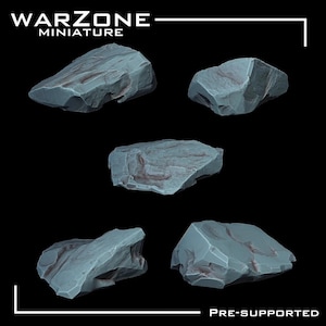 May include: Five grey miniature rock formations with textured surfaces are displayed against a black background. The rocks have a rough, natural appearance, with subtle colour variations. The top left corner of the image reads "WARZONE MINIATURE". The bottom right corner reads "PRE-SUPPORTED".