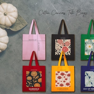 May include: A collection of cotton canvas tote bags in various colors, including pink, black, red, yellow, green, and blue. Each bag features a floral design or pattern. The pink bag is 15 inches wide and 16 inches long.