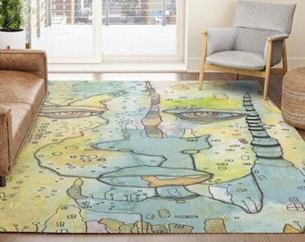 Könnte beinhalten: Abstrakter Aquarell-Teppich mit einem Gesichtsdesign in Blautönen, Grün- und Gelbtönen. Der Teppich zeigt ein stilisiertes Gesicht mit zwei Augen, einer Nase und einem Mund.