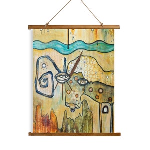 May include: Abstract art print on canvas with a whimsical, colorful design featuring a creature with large eyes, a swirling pattern, and a textured background. The print is mounted on a wooden frame with a hanging rope.