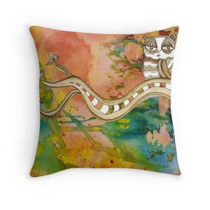 May include: A watercolour pillow featuring a stylised owl perched on a branch with a swirling, abstract background in shades of orange, yellow, green, and blue.