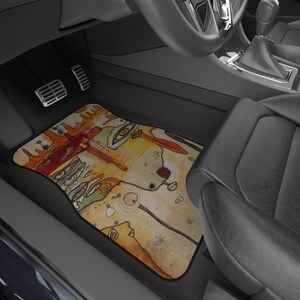 May include: A colorful abstract art car floor mat with a yellow, orange, red, green, and brown design. The mat is made of a durable material and is designed to protect your car's floor.