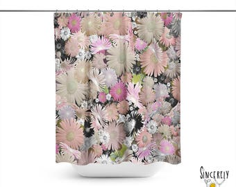 May include: A shower curtain featuring a floral pattern with pink, white, and gray daisies. The daisies are arranged in a random pattern and overlap each other.