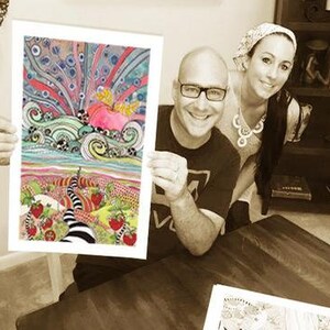 May include: A couple holding a colorful, whimsical art print featuring a swirling, abstract design with a pink heart and a black and white path leading to a field of strawberries.