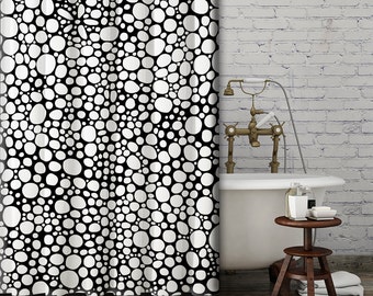 May include: Black and white shower curtain with a pattern of white circles on a black background.
