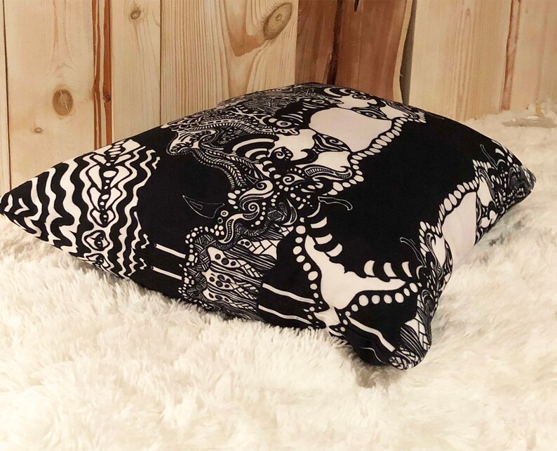 May include: Black and white patterned throw pillow with a geometric design. The pillow is made of a soft, comfortable fabric and has a zipper closure.