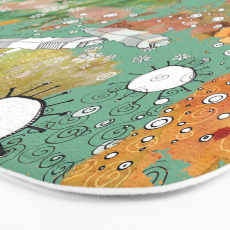 May include: Abstract art bath mat with a green, orange, and white color scheme. The design features swirling lines, circles, and abstract shapes.