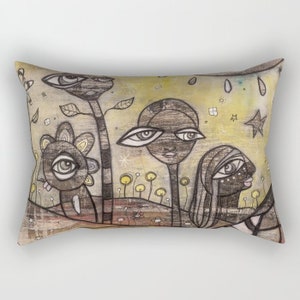 May include: A rectangular throw pillow with a whimsical illustration of four stylized faces with large eyes. The faces are drawn in black and white on a yellow background with black and white accents. The background also features small yellow flowers and a star.
