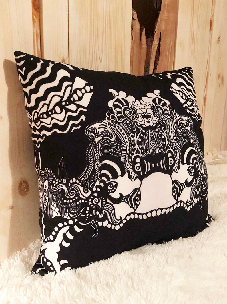 May include: Black and white decorative pillow with an abstract design featuring swirling patterns and shapes.