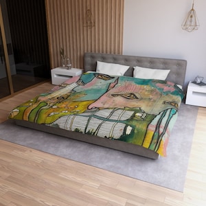 May include: A colorful abstract duvet cover with a green, blue, and yellow background. The duvet cover features a large, abstract face with eyes, nose, and mouth.