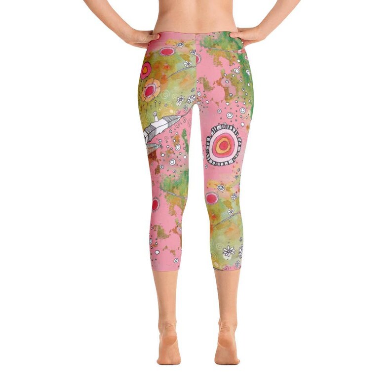 May include: Pink and green patterned leggings with a whimsical design featuring flowers, circles, and abstract shapes.
