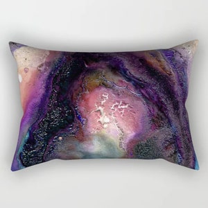 May include: Abstract pillow cover with a swirling pattern of purple, pink, blue, and white. The design resembles a galaxy or nebula.