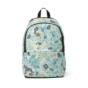 May include: A blue and green backpack with a black zipper and a pattern of abstract shapes.