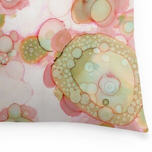 May include: Abstract art print featuring a pattern of overlapping circles in shades of pink, green, and brown. The circles are arranged in a random pattern, creating a sense of movement and energy.