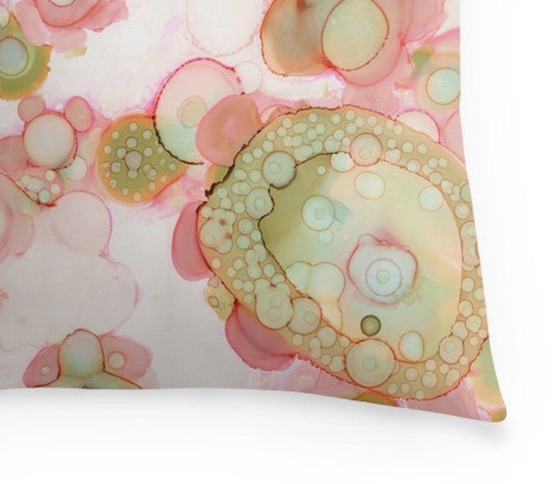 May include: Abstract art print featuring a pattern of overlapping circles in shades of pink, green, and brown. The circles are arranged in a random pattern, creating a sense of movement and energy.