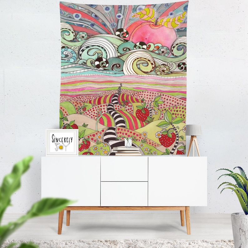 May include: A colorful tapestry featuring a whimsical landscape with a winding path leading to a pink apple in the sky. The path is lined with hearts and strawberries, and the background is filled with swirling clouds and a rainbow.
