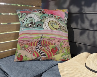 May include: A colorful throw pillow with a whimsical design featuring a landscape with hills, waves, and strawberries. The pillow is made of fabric and has a square shape.