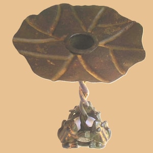 May include: A bronze-colored, decorative hanging lamp with a leaf-shaped top and a frog-themed base. The lamp features a twisted stem and a detailed design, perfect for adding a unique touch to any space.