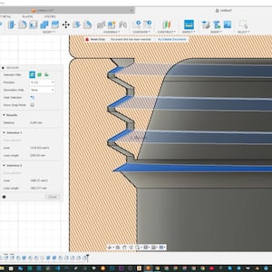 May include: A close-up view of a 3D model of a screw thread. The thread is made of metal and has a blue and gray color scheme. The thread is being measured in a computer aided design program.