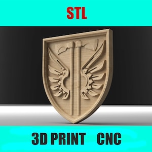 May include: A wooden shield design with a central axe and wing details. The shield is light brown and has the text "STL" at the top and "3D PRINT CNC" at the bottom. The design is likely for 3D printing or CNC machining.