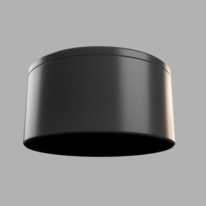 May include: A black cylindrical container with a smooth, glossy finish. The container is empty and has a rounded top and bottom.