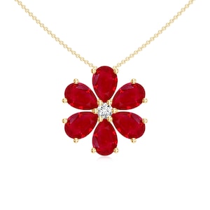 May include: A gold necklace with a red ruby flower pendant. The flower has six petals and a small diamond in the centre.
