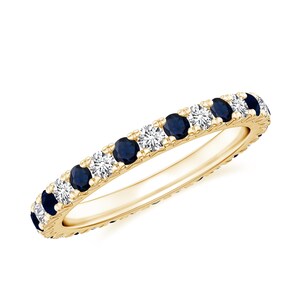 May include: A gold band ring with alternating blue sapphires and white diamonds.