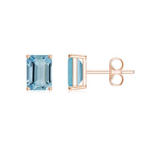 May include: A pair of rose gold earrings with emerald cut aquamarine gemstones.