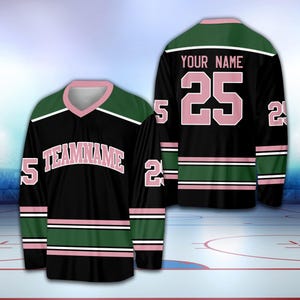 May include: Black hockey jersey with pink and green stripes. The jersey has the text "TEAMNAME" and the number "25" on the front. The back of the jersey has the text "YOUR NAME" and the number "25" on the back.