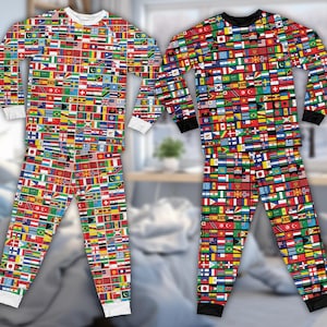 May include: Two matching pajama sets, one with a white collar and cuffs, the other with black. Both sets feature a vibrant, all-over print of various national flags. The long-sleeved tops and pants are displayed against a blurred background.