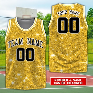 May include: Gold basketball jersey with a black number "00" and the text "TEAM NAME" on the front. The back of the jersey has the text "YOUR NAME" and the number "00".