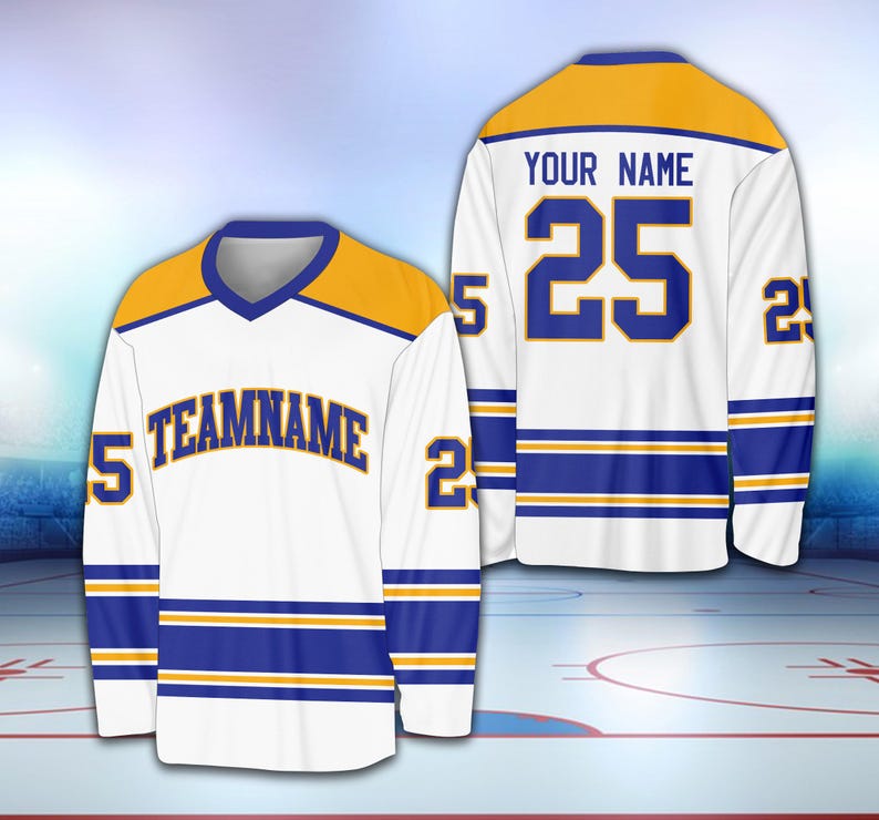 May include: White hockey jersey with blue and gold stripes. The jersey has a gold collar and a gold nameplate with the text "YOUR NAME" and the number "25" in blue. The jersey also has a blue nameplate with the text "TEAMNAME" in gold.