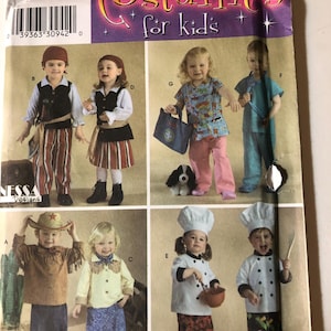 May include: Simplicity costume pattern for kids, featuring various costume designs. The pattern includes options for a pirate, cowgirl, chef, and other outfits. The packaging is purple and yellow.