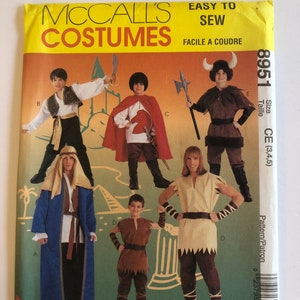 May include: A sewing pattern for five different costumes. The pattern is for sizes 3, 4, and 5. The costumes include a Viking, a knight, a shepherd, a desert nomad, and a barbarian. The pattern is from McCall's Costumes and is easy to sew.