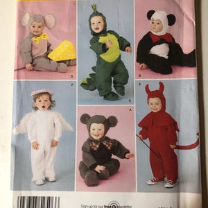 May include: Simplicity pattern for toddler costumes. The cover features six different costume designs: a mouse, a dinosaur, a panda, an angel, a bear, and a devil. The costumes are in various colors, including gray, green, black, white, and red.