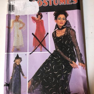 May include: Simplicity Costumes sewing pattern featuring various costume designs. The cover showcases a woman in a black dress with a crescent moon pattern, a red dress, and a witch costume. The pattern size is 14-20.