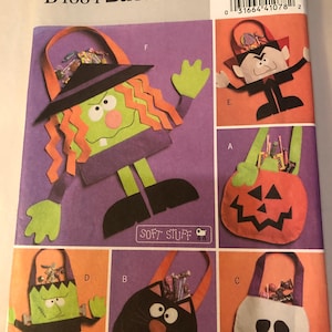 May include: Butterick B4884 sewing pattern for Halloween-themed treat bags. The pattern features designs for a witch, vampire, pumpkin, Frankenstein's monster, black cat, and skull. The bags are made of soft material and are one size.