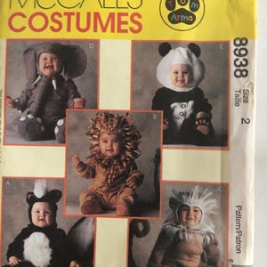 May include: A McCall's Costumes pattern envelope featuring images of babies in animal costumes: an elephant, panda, lion, skunk, and lion. The envelope is yellow with the text "MCCALL'S COSTUMES" in red.