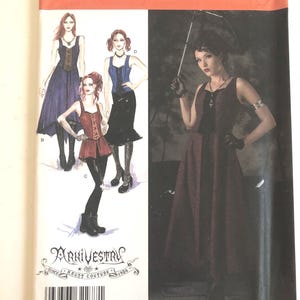 May include: Simplicity sewing pattern 2757 featuring gothic-inspired designs. The pattern includes illustrations of dresses and tops with corset-style bodices. The cover also features the text "ARKIVESTRY" and "HAUNT COUTURE 1986".