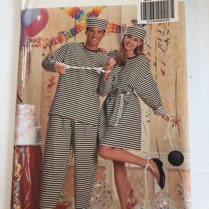 May include: Butterick sewing pattern 4970 featuring a couple in black and white striped prison costumes. The pattern includes a long-sleeved shirt, pants, and a hat. The image shows the costumes with ball and chain props.