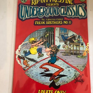 May include: A comic book cover with a red background and the title "Rip Off Press Inc. Presents Underground Classics: The Fabulous Furry Freak Brothers No. 0". The cover features a cartoon illustration of three characters in a city setting. The comic book is labeled "Adults Only".