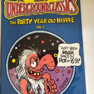 May include: A comic book cover featuring a cartoon of a long-haired, long-nosed man with a large grin. The title of the comic is "The Forty Year Old Hippie" and the text "Ain't Been High Since The Pot of '69!" is in a speech bubble above the man's head.