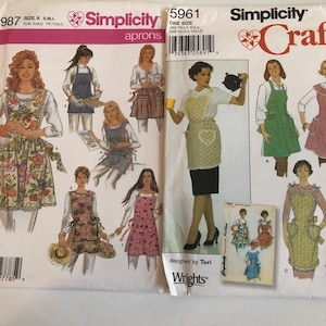 Simplicity 5961 Uncut Aprons Pattern. 4 Styles. One Size OR Simplicity 4987 Uncut Aprons Pattern. 6 Styles. Sizes S,M,L.