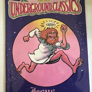 May include: A comic book cover featuring a cartoon illustration of Jesus running with a halo above his head. The cover is pink and purple with stars and the title "Jesus vol. 1" by Foolbert Sturgeon.