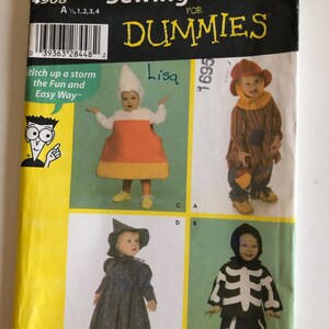 May include: Simplicity Sewing Patterns for Dummies, a pattern booklet for toddlers' costumes. The cover features four different costume ideas: a witch, a skeleton, a scarecrow, and a corn on the cob. The pattern number is 4908.