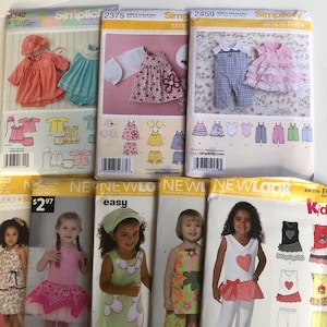 May include: A collection of sewing patterns for baby and children's clothing. The patterns feature various designs, including dresses, tops, and pants. The patterns are from the brands Simplicity and New Look, with images of the finished garments on the covers.