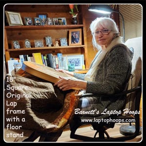 May include: A woman sits in a chair with a 18" square wooden frame lap desk on her lap. The desk is made of wood and has a brown finish. The woman is wearing a gray sweater and has white hair. The desk is on a stand and has a floor stand. The text "Barnett's Laptop Hoops" and "www.laptophoops.com" is visible on the desk.
