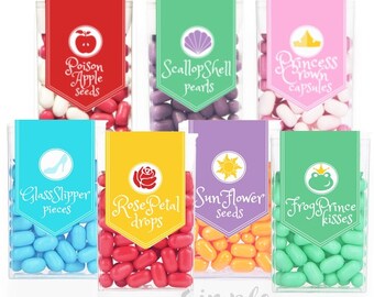 May include: Six clear plastic containers filled with colorful candies. Each container has a label with a princess-themed design and a whimsical name for the candy, such as "Poison Apple Seeds", "Scallop Shell Pearls", and "Frog Prince Kisses".