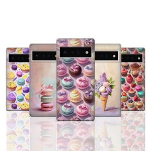 May include: Six different phone cases with pastel colours and designs featuring macarons, cupcakes, and flowers. The cases are all for smartphones.
